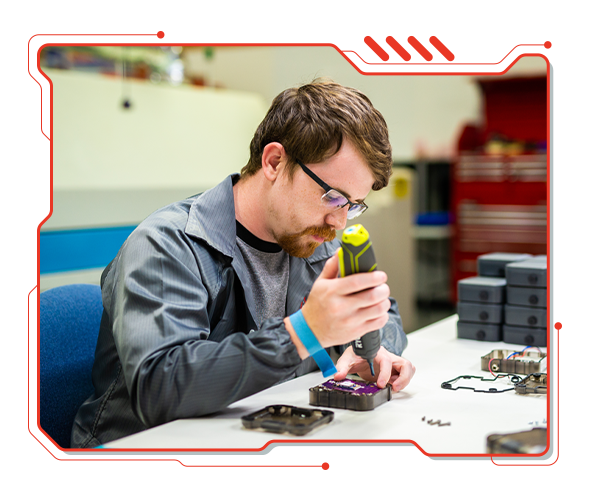 Pic of a Manufacturing Technican completing a IoT device